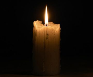 gpt-image-2_A_hyper-realistic_4K_photograph_of_a_single_white_pillar_candle_half_burned_down-0